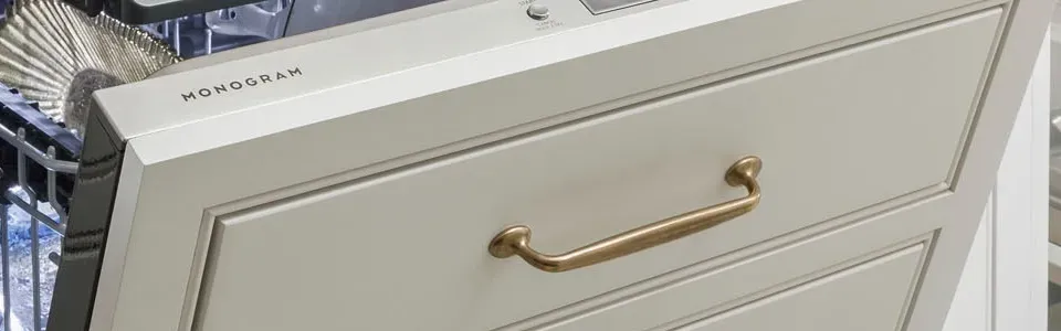 dishwasher featuring a custom made brass handle